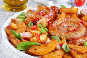 hot fried sausages and potato on platter