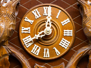 Front of a vintage clock made by wood
