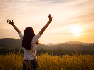 Silhouette woman rising hands and face to sunlight in the morning with freedom, fresh, soft feeling.