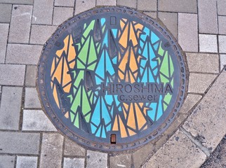 Manhole cover of Hiroshima engraved with origami paper cranes. The one thousand origami cranes were through the story of Sadako Sasaki, victims of nuclear warfare.