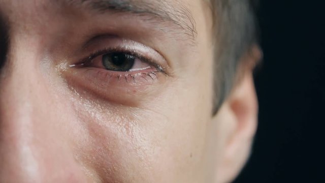 Shot of Crying man with tears in eye closeup