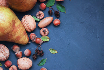 Nuts on dark blue wooden table. Autumn background. Top view