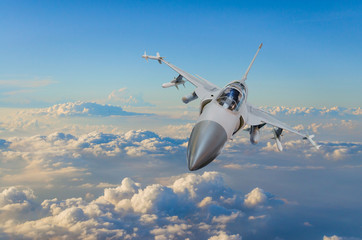 Military fighter jet against a blue sky with a backlight from below.