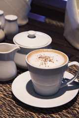 Hot cocoa in white mug and white glassware props.