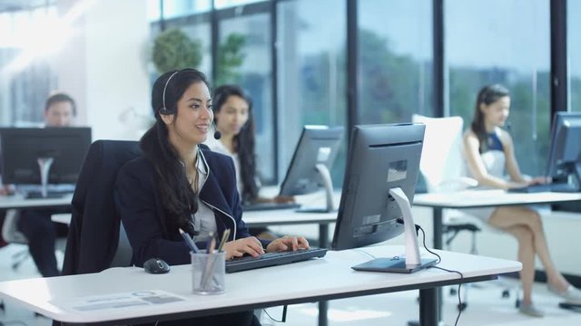  Friendly customer service operator talking to customer in busy call centre