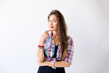 Fototapeta premium Thoughtful and smiling young woman