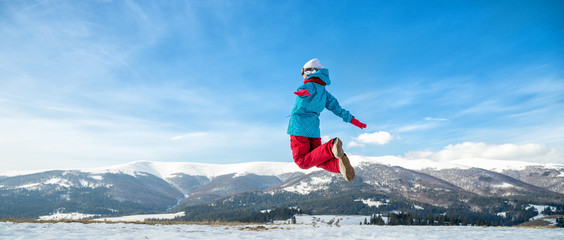Young woman jumping in the mountains