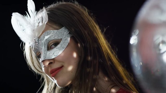  Beautiful girl wearing carnival mask at glamorous party