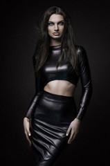 Fototapeta na wymiar Beautiful goth mistress evil girl in black latex dress