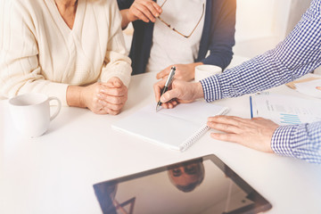 Pleasant aged couple meeting with real estate agent