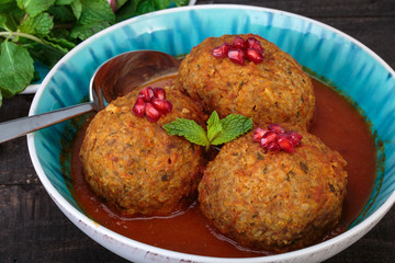 Koofteh Tabrizi Large Meatballs Stuffed With Dried Fruits, Berries And Nuts In Tomato Turmeric Broth A Traditional Azeri And Iranian Dish Served In Turquoise Bowl Garnished With Pomegranate
