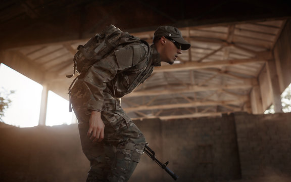 a soldier in uniform and an automatic machine in his hands