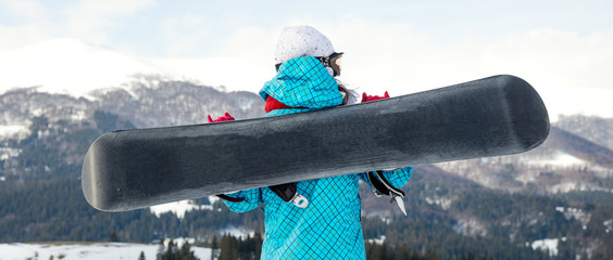 snowboarder girl standing with snowboard,