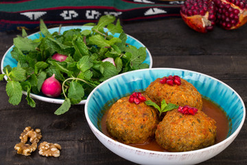 Koofteh Tabrizi Large Meatballs Stuffed With Dried Fruits, Berries And Nuts In Tomato Turmeric Broth A Traditional Azeri And Iranian Dish Served In Turquoise Bowl Garnished With Pomegranate