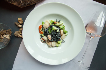 Fresh black tagliolini pasta with scallops