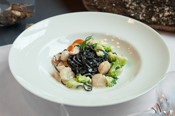 Fresh black tagliolini pasta with scallops