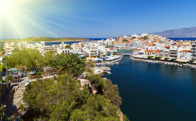 Fototapeta na wymiar The lake Voulismeni in Agios Nikolaos, picturesque coastal town with colorful buildings around the port in the eastern part of the island Crete, Greece