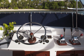 Steering wheel and control panel on yacht.