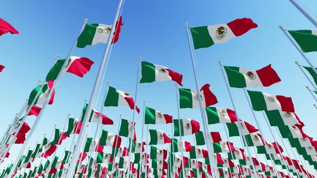 Many Mexican flags on flagpoles against blue sky. Three dimensional rendering 3D rendering animation.