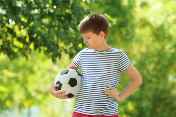 Obraz premium Cute boy with soccer ball in park