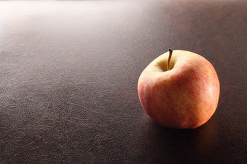 apple with mood in brown background