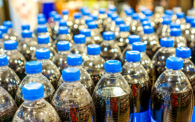 many pepsi bottles stand in strong rows