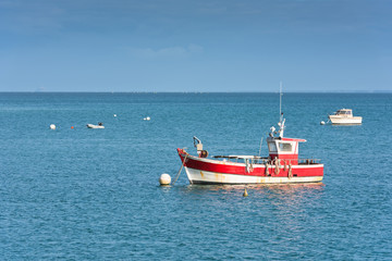 Fototapeta na wymiar Bright blue sea and fisherman boats