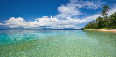 Fototapeta na wymiar Panoramic view of tropical beach on background the islands