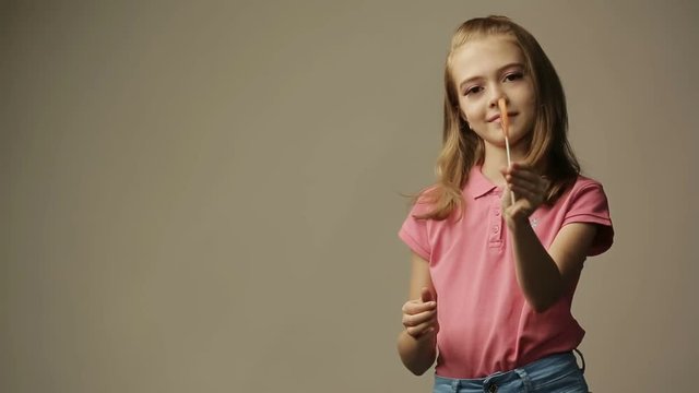 Girl licking lollipop candy