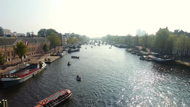 Tourist boats in the canal of Amsterdam, aerial view
