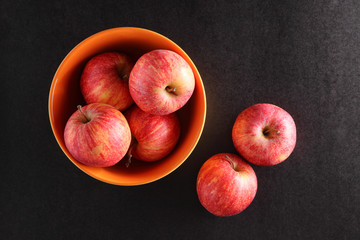 apples on a bowl with dark background