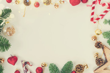 Christmas flat lay styled scene - top view frame with evergreen tree twigs and decorations, retro toned