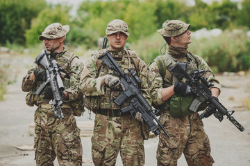 Soldiers on patrol in destroyed city. Military and rescue operation concept.