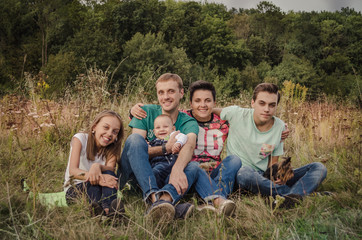 Obraz premium Happy young family spending time together outside in green nature.