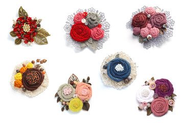 Seven charming female handmade decorations made from fabric on a white background