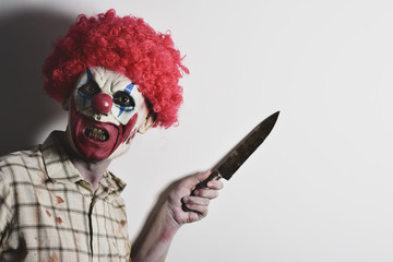 scary evil clown with a big knife