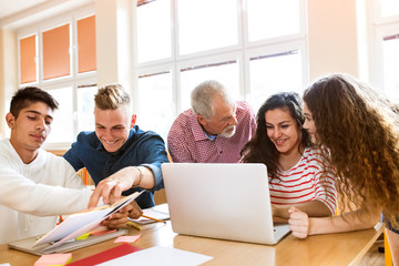 High school students and teacher with laptop.