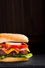 Delicious hamburger on a dark background