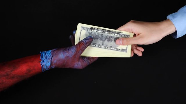Businessman gives money to bloody doctor.