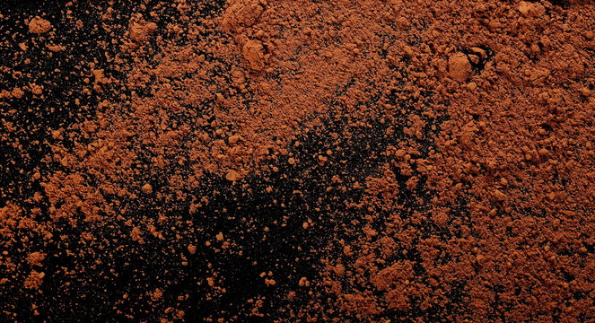 pile cocoa powder isolated on black background