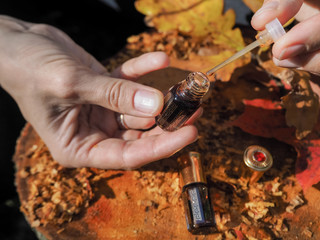 A woman opens the perfume oil. Scented oil in women's wrists. Arabian perfume oil.
