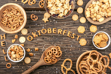 Snacks on wooden table. Word Oktoberfest made of salty crackers letters. Top view