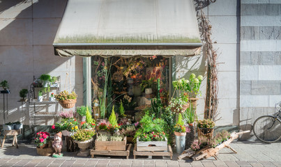 Flowers on display on the street in a flower shop in Como, Italy