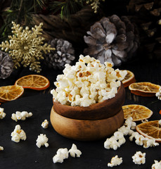 popcorn in a wooden plate on the background of Christmas