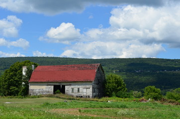 Beautiful old weathered barn on an upstate New York hillside in summer 