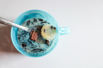 Pile of brownies with milk and banana