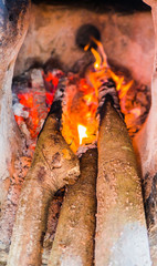 Closeup firewood and fire ,bright flame in the fireplace .