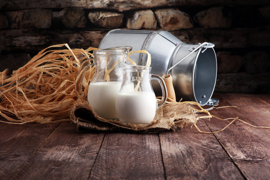 A Jug Of Milk And Glass Of Milk On A Wooden Table