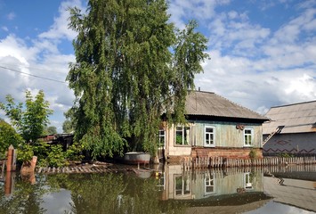 Flood. The river Ob, which emerged from the shores, flooded the outskirts of the city.Boats near the houses of residents