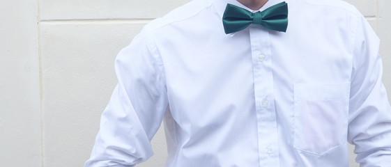 Groom in white shirt with green bow tie